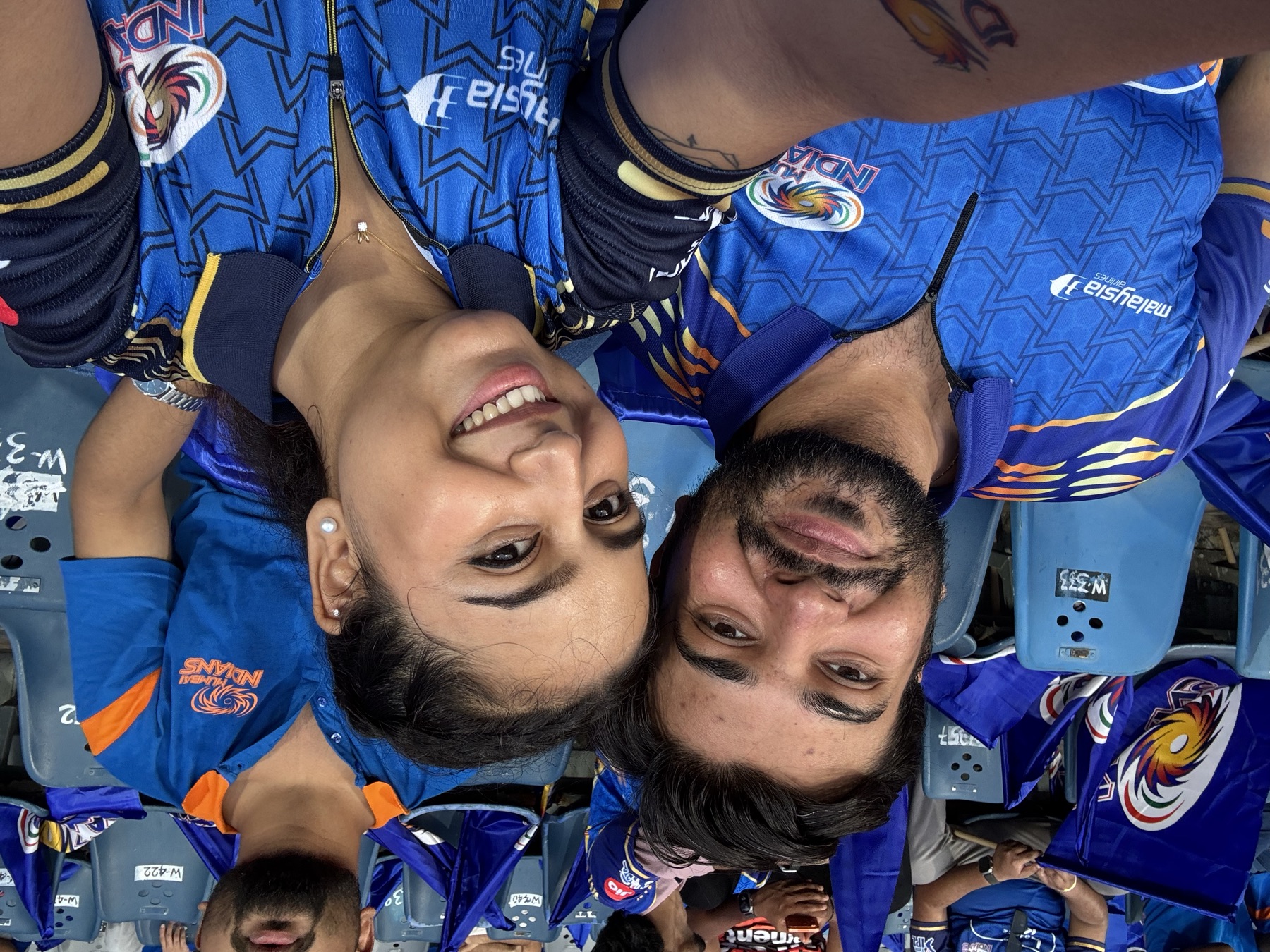 Us at an IPL match in Mumbai Indians jerseys