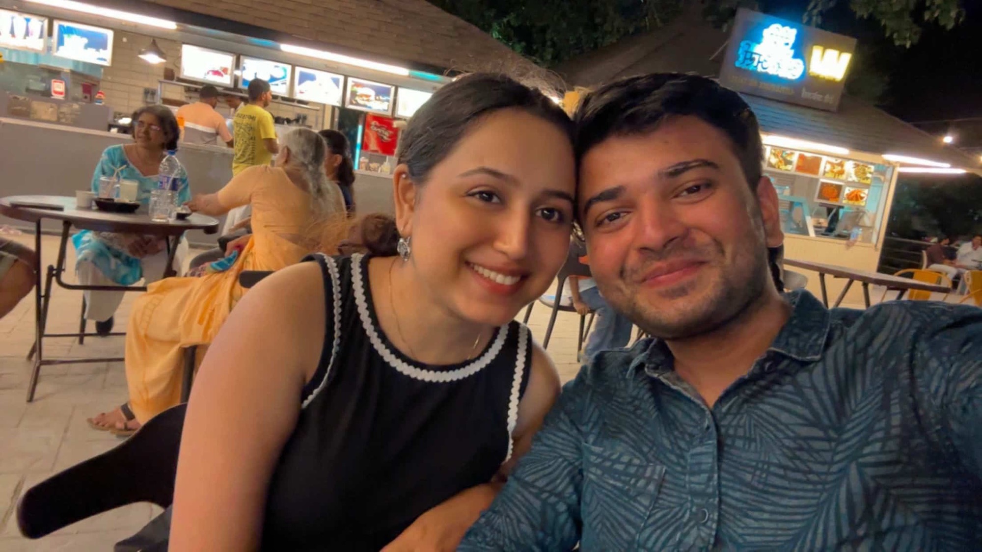 Us smiling together at a café in Mumbai