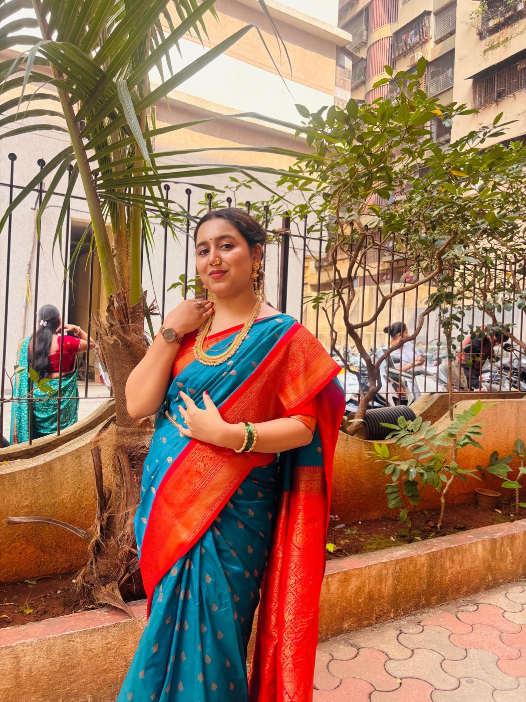 Unnu dressed in a blue and red sari
